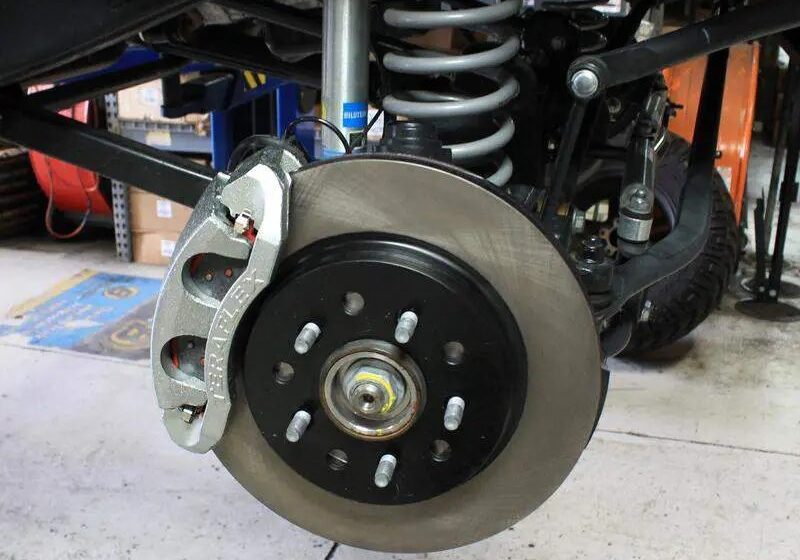 A close up of the front brake disc on a car